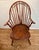 This fine brace-back, nine-spindle continuous arm Windsor chair is stamped "I SPROSEN" on the underside of the seat,...