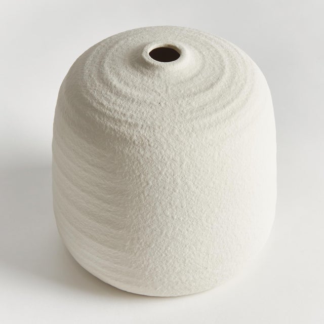 A classic rotund shape and a very narrow opening makes this vase perfect for a single branch or tall faux floral stem. The...