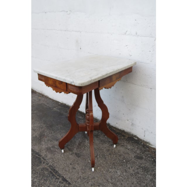 This gorgeous Side Table is made out of wood, solid wood, walnut, veneer, and marble. The End Table has Victorian Eastlake...