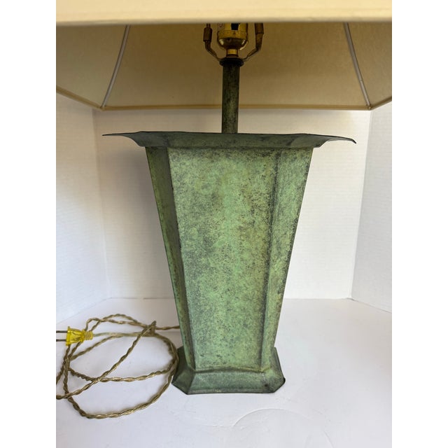 Here is a sophisticated vintage table lamp featuring a sculptural, geometric base with an angular form and a verdigris-...