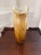 Handblown vintage art glass vase in a striking flared trumpet form, featuring warm amber and honey tones that deepen...