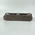 A carved double headrest from the Songye people is a sculptural sleeping support traditionally used in the savanna regions...