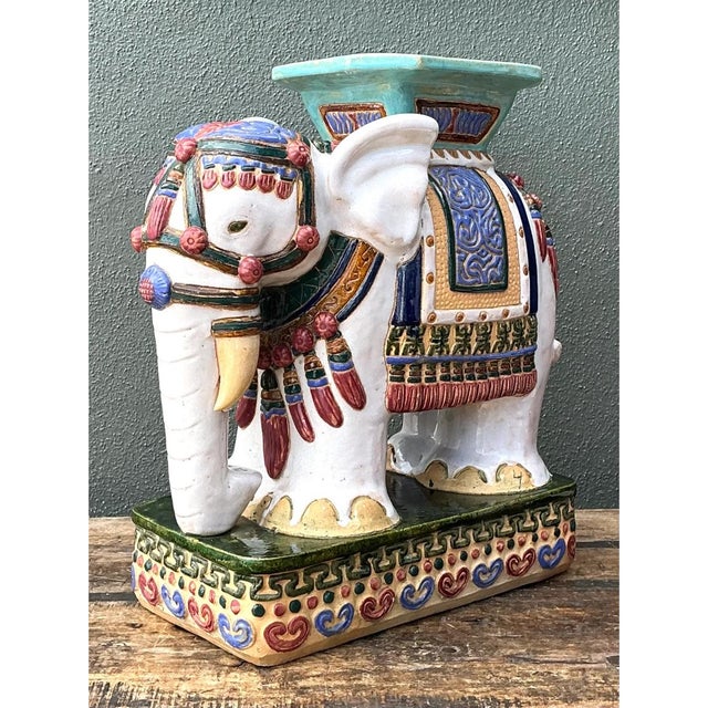 This vintage ceramic elephant low stool showcases exceptional decorative artistry, its charming figural form rendered in...
