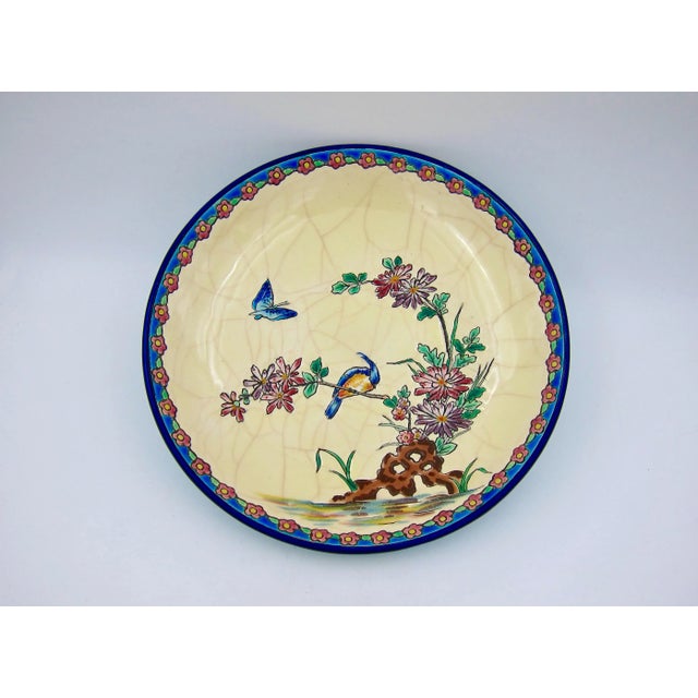 A hand-decorated French Emaux de Longwy pottery shallow bowl resting on a ring foot with an incised, cloisonné-style...