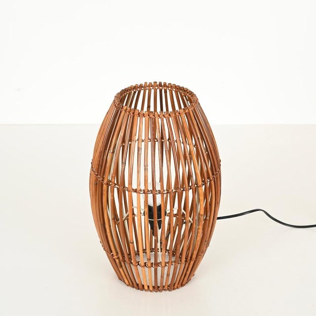 Stunning mid-century table lamp entirely crafted from curved bamboo and hand-woven rattan wicker. This stylish and unique...