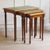 This three-piece nesting table set is stylistically related to late historicism. The graduated proportions, the slender...