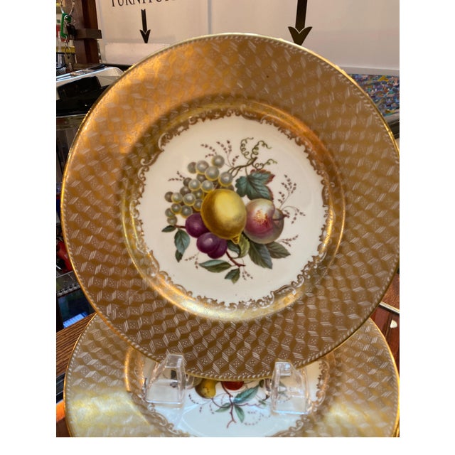 An opulent set of 10 hand painted 9 inch diameter plates, England Circa 1900-1910. These plates with hand painted centers...