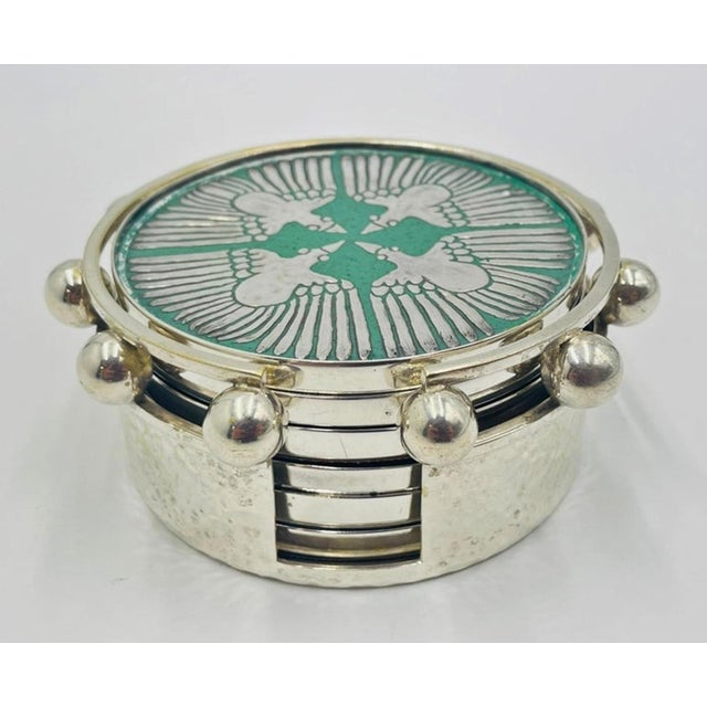 A rare and highly collectible vintage coaster set designed and manufactured in Taxco, Mexico by renowned Mexican...