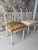 An elegant and highly decorative pair of antique neoclassical side chairs with remarkable provenance, sourced from the...