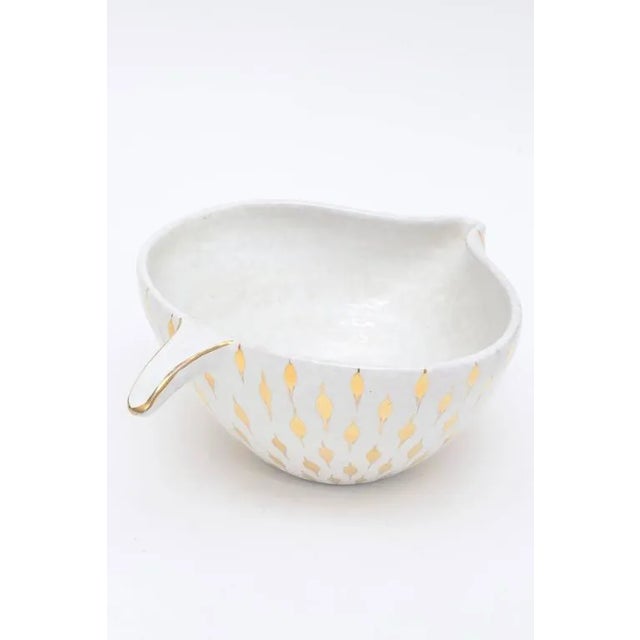 This sculptural Italian Aldo Londi for Bitossi ceramic bowl or vessel has gold painted teardrop like surround shapes on...