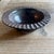 A vintage studio pottery bowl featuring a rich Tenmoku glaze with subtle oil-spot characteristics and dimensional color...