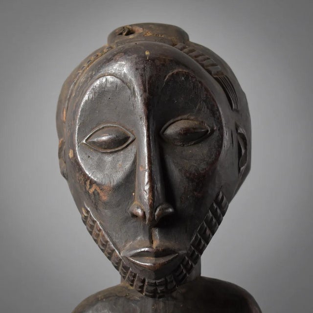 A stunning Hemba Male Figure Carving from the Democratic Republic of the Congo. Exaggerated proportions, such as the head...