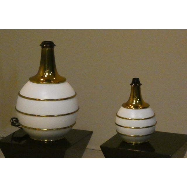 Mid-century modern italian table lamps from the 1970s, characterized by hollywood regency influences. they feature a...