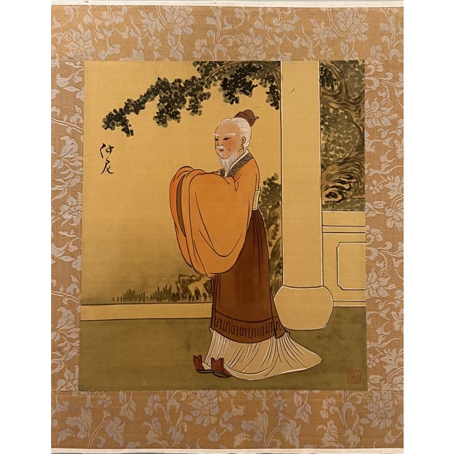 A framed 'gouache' painting on gold toned silk depiciting an old Chinese man - possibly an scholar, ancestor or sage in a...