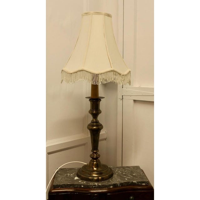 Large French brass candlestick table lamp. This is a very good quality and very heavy piece, the lamp looks like a huge...