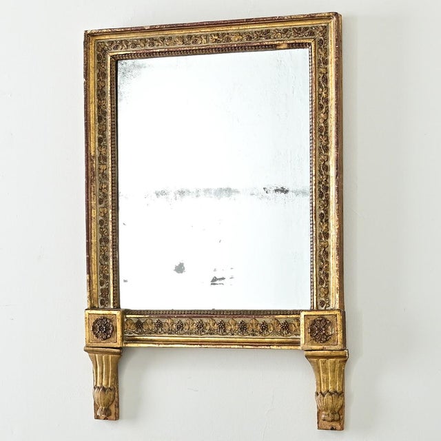 Dimensions: 33 ⅝” H x 23 ⅛” W x 2 ¼” D A wonderful 18th century French gold giltwood mirror, likely made as a wedding...