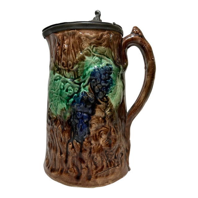 Antique 19th Century Majolica Pitcher /Jug With Pewter Top Decorated With a Vibrant Grape & Vine Pattern Against a Brown Tree-Like Textured Background For Sale