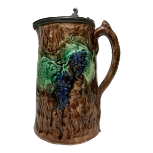 Antique 19th Century Majolica Pitcher /Jug With Pewter Top Decorated With a Vibrant Grape & Vine Pattern Against a Brown Tree-Like Textured Background