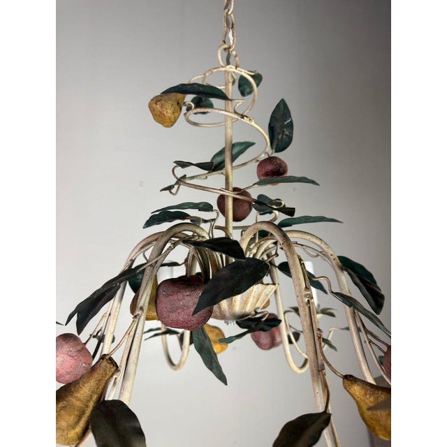 A sculptural and highly decorative Italian tole chandelier, dating to the mid-20th century (circa 1940s–1950s), featuring...