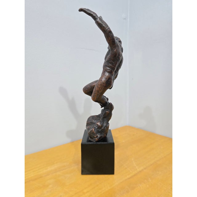 ​Captured in a moment of dramatic, fluid motion, this original composition depicts a bare-chested male dancer leaping...