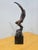 ​Captured in a moment of dramatic, fluid motion, this original composition depicts a bare-chested male dancer leaping...