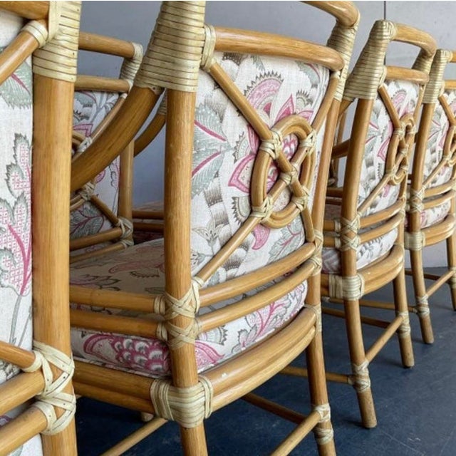 Golden rattan, McGuire target back arm chair. Upholstered in a designer chinoiserie fabric in pink and olive green. Well...