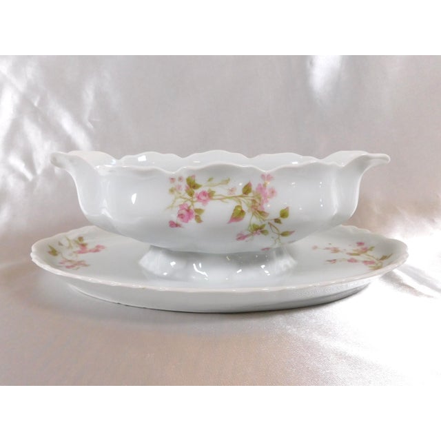 This is a Heinrich & Co. Gravy boat with attached underplate in pattern number HC441 from 1911. It is white with pink...