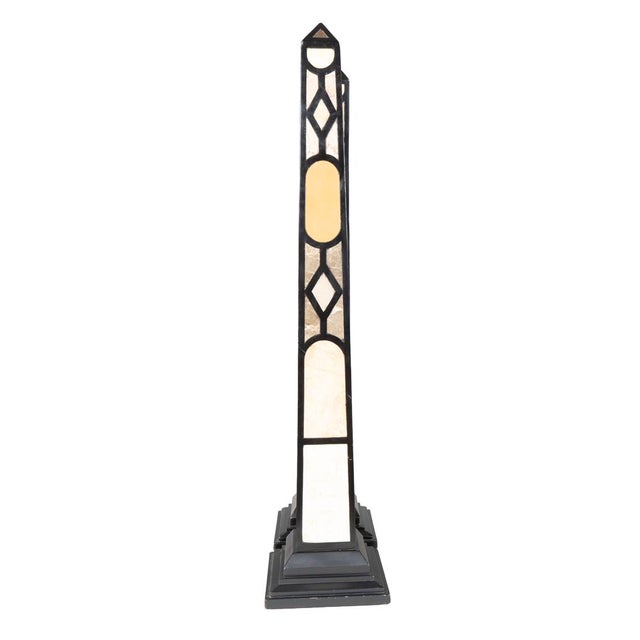 Pair of large obelisks wit a ebonized wood frame with various stone inlays.