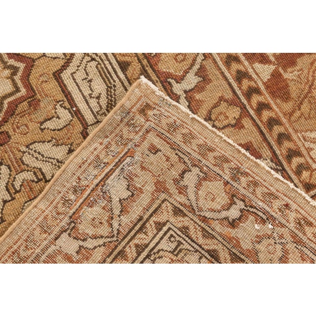 An early 20th century Indian Amritsar rug, the sand field with an allover trellis of scrolling flowering vine and...