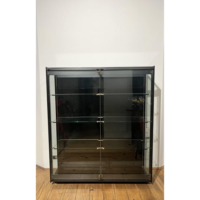 Extremely rare sculptural display case in tempered glass and specially worked steel. Shelf supports, hinges, locks, and...