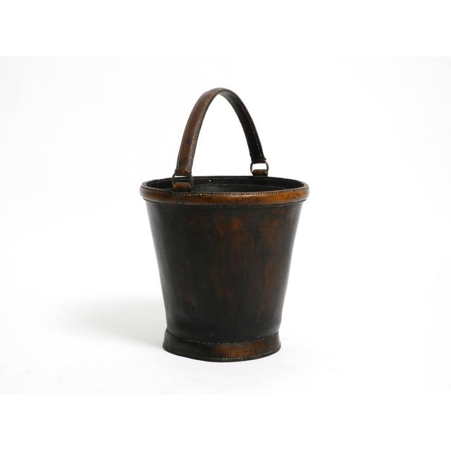 Large, heavy mid-century modern wastepaper basket made of robust, thick, dark brown cowhide. Can also be used for other...