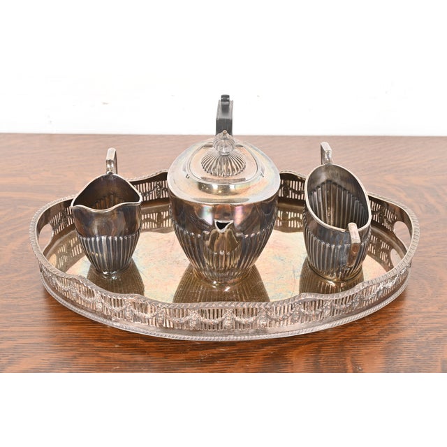 A gorgeous English Victorian or Art Deco silver plate service set, including: tea pot, creamer, sugar bowl, and large...
