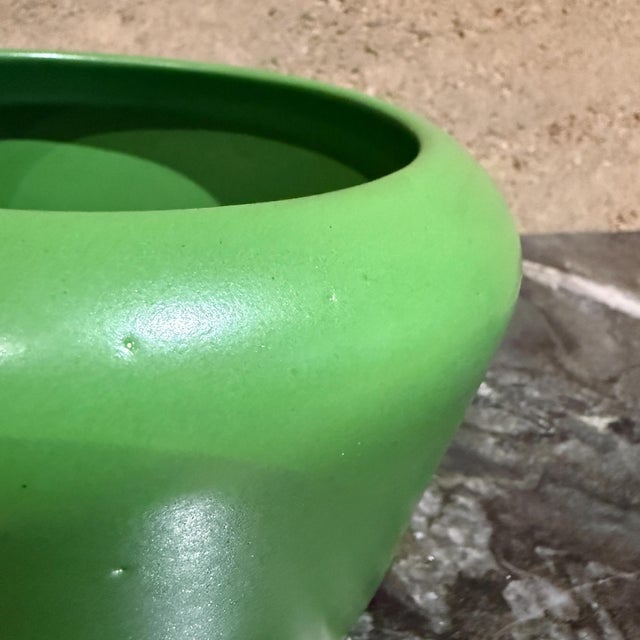 For your consideration, a vintage or modern ceramic planter or pot in a vibrant green color. The object features a wide,...