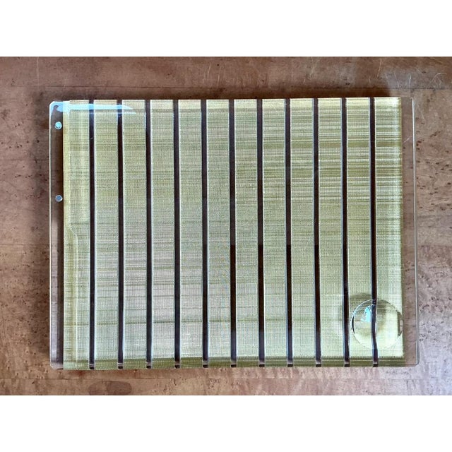 This vintage tray is crafted from a solid slab of clear lucite, its flat rectangular form finished with gently rounded...