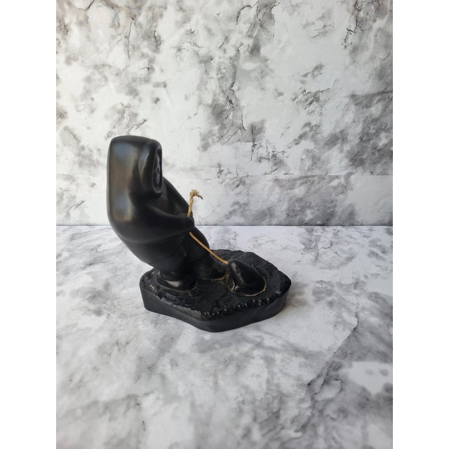 Canadian Inuit small figurine carving. This item is made of resin/acrylic. Sticker at base says Boma.