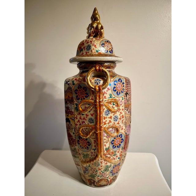 Made of fine porcelain and featuring ornate handles, this very large lidded ginger jar vase has stunningly beautiful,...