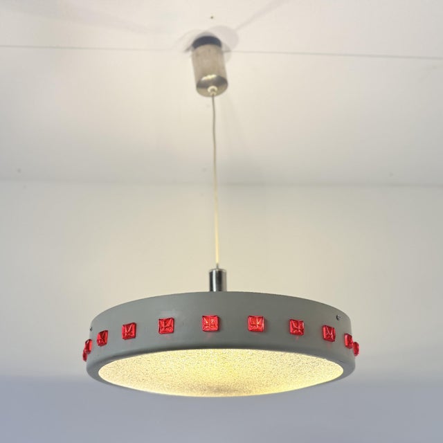 Nice vintage UFO lamp from the 1970s. The lamp consists of three E27 light bulbs, which shine through the plastic disc at...