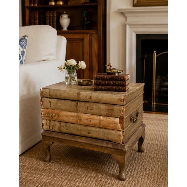 A wonderfully theatrical vintage side table designed as a stack of four oversized, timeworn books. The wood structure is...