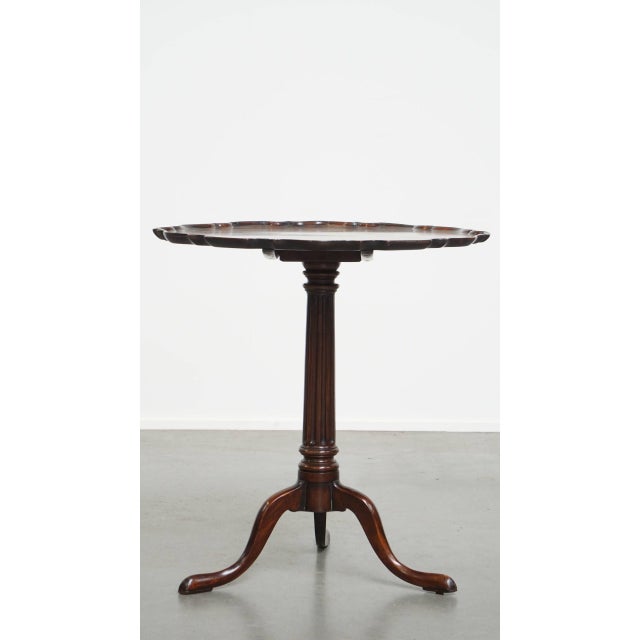 Offered this charming antique English wine/ tilt top table/ side table from the 19th century with an ornate one piece top....