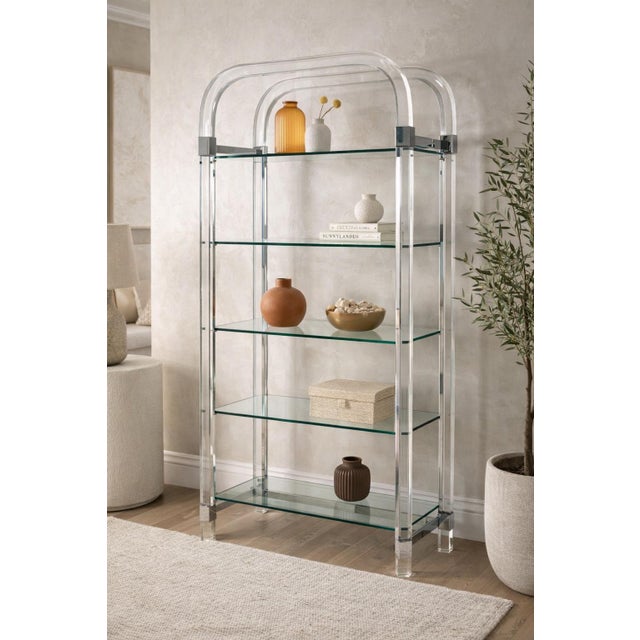 A striking and architecturally scaled Lucite and chrome étagère designed and manufactured in the United States by Charles...