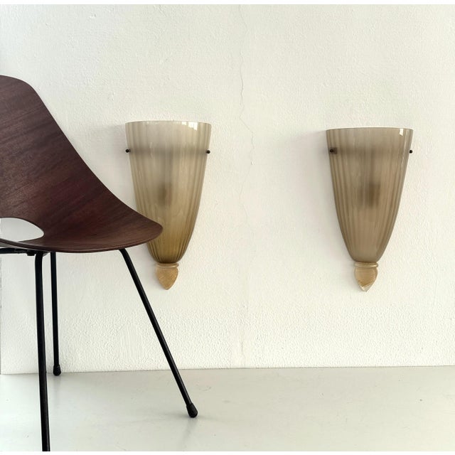 Pair of extralarge and elegant wall sconces made of murano glass in the 1970s, typical italian style. both light sconces...