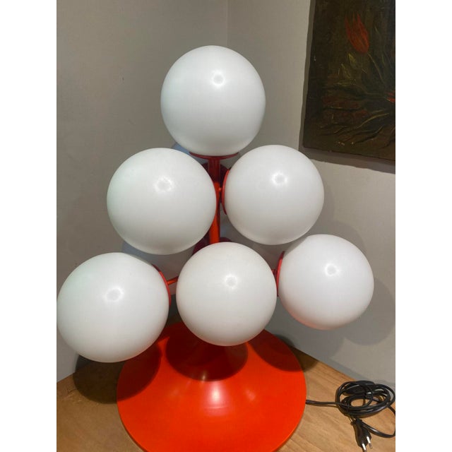 Lamp with 10 satin glass spheres on an orange painted metal frame. It has been converted into a table lamp. Good...