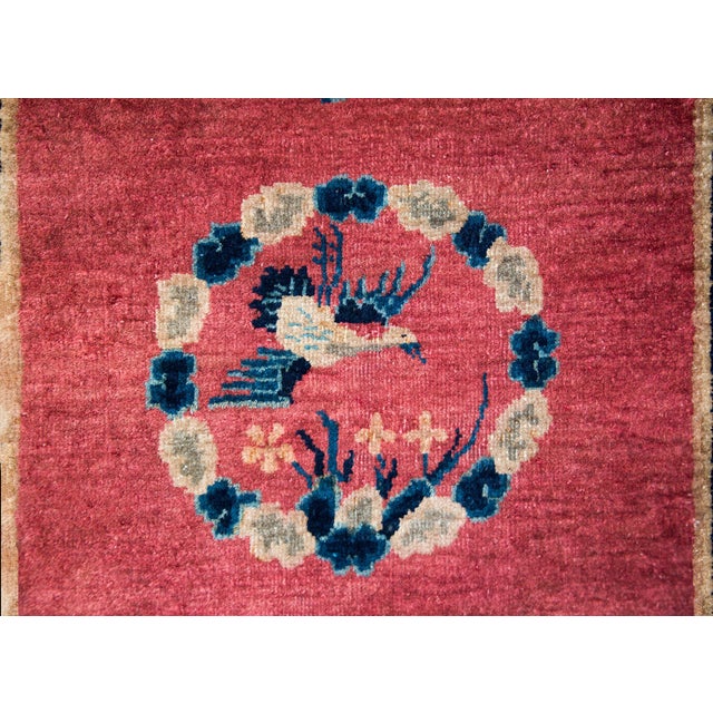 A wonderful early 20th century Chinese Art Deco rug with a central billowing cloud medallion surrounding a Phoenix, and...