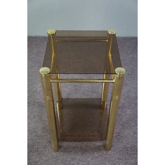 This strikingly designed mid-century side table. This nice vintage table has a beautifully shaped frame and two beautiful...