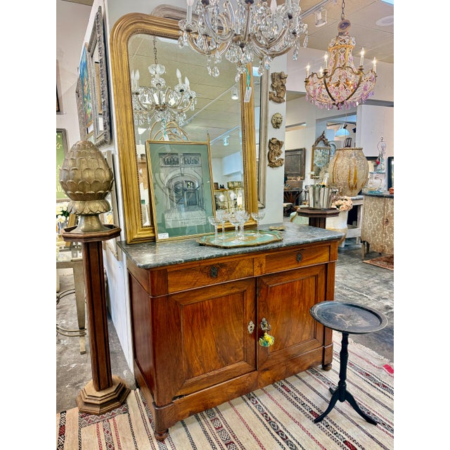 This 20th Century antique French buffet with a Belgian marble top, sourced in France, showcases timeless elegance and fine...