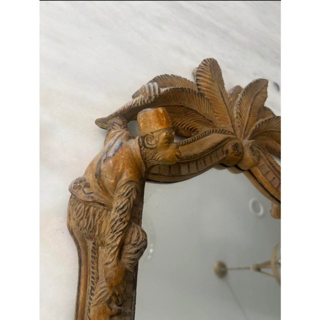 1980s monkey and palm frond wall mirror in the Hollywood Regency, Palm Beach, and Chinoiserie style, featuring tropical...