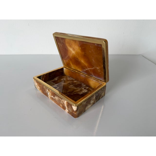 A beautiful 1960s Italian jewelry box handcrafted from richly patterned natural agate stone, showcasing warm amber,...