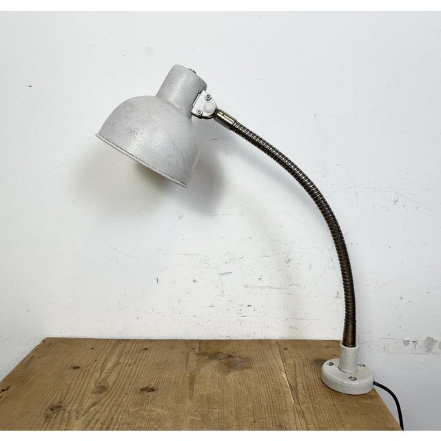 Industrial adjustable workshop table lamp made in former Czechoslovakia during the 1960s.It features a grey iron base and...
