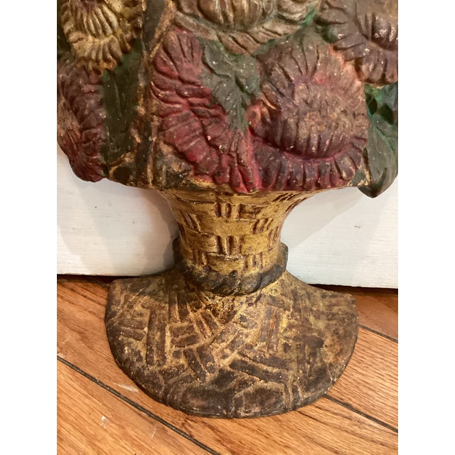 Waverly Studio copyright 1925. Manufactured in Wilmette, Illinois and made of cast iron. A bouquet of red flowers in a...