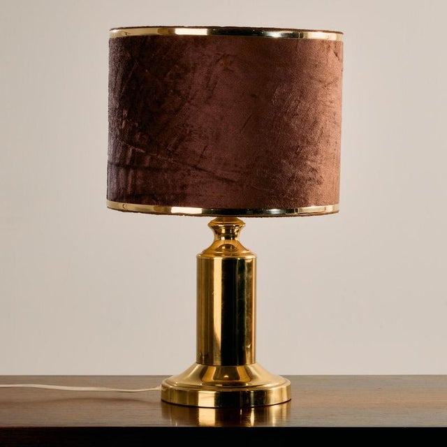 A truly classic and elegant piece. German brass table lamp with rounded shapes and a velvet lampshade from the 1970s. The...